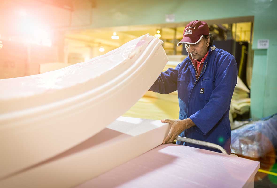 a man checking out the mattress foam